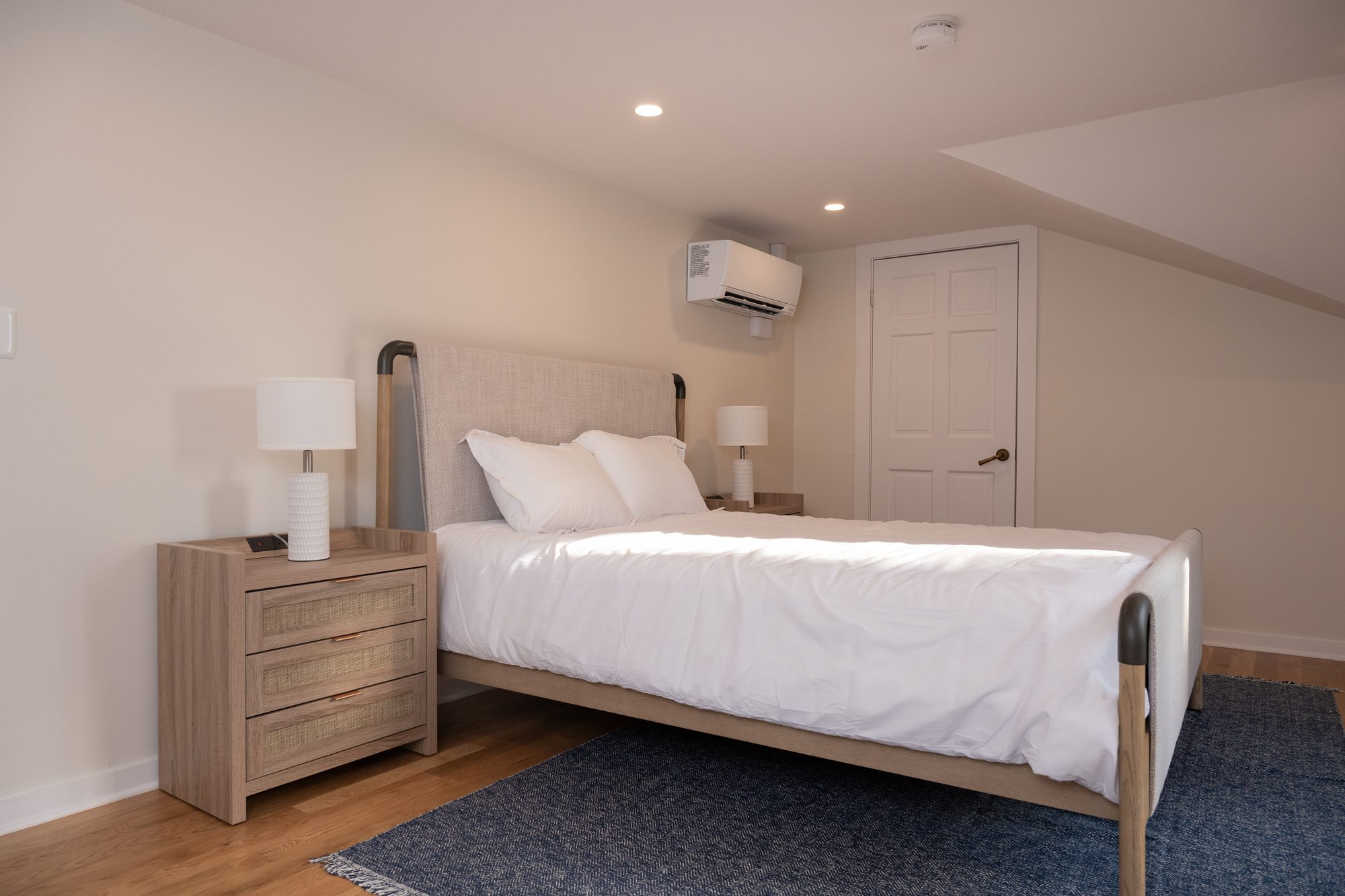 Queen bedroom with a wood headboard