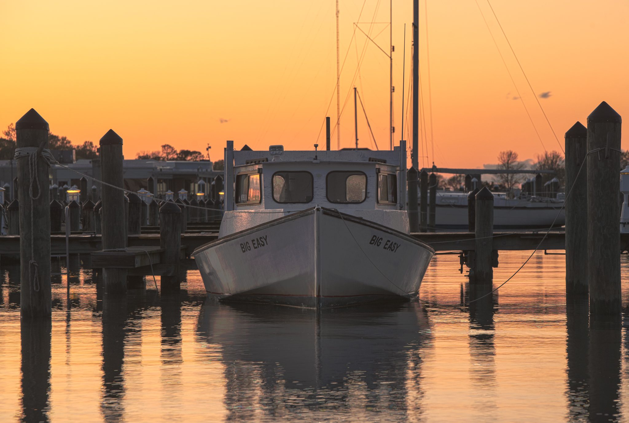 A Chesapeake workboat at its mooring at sunset on the Cambridge waterfront