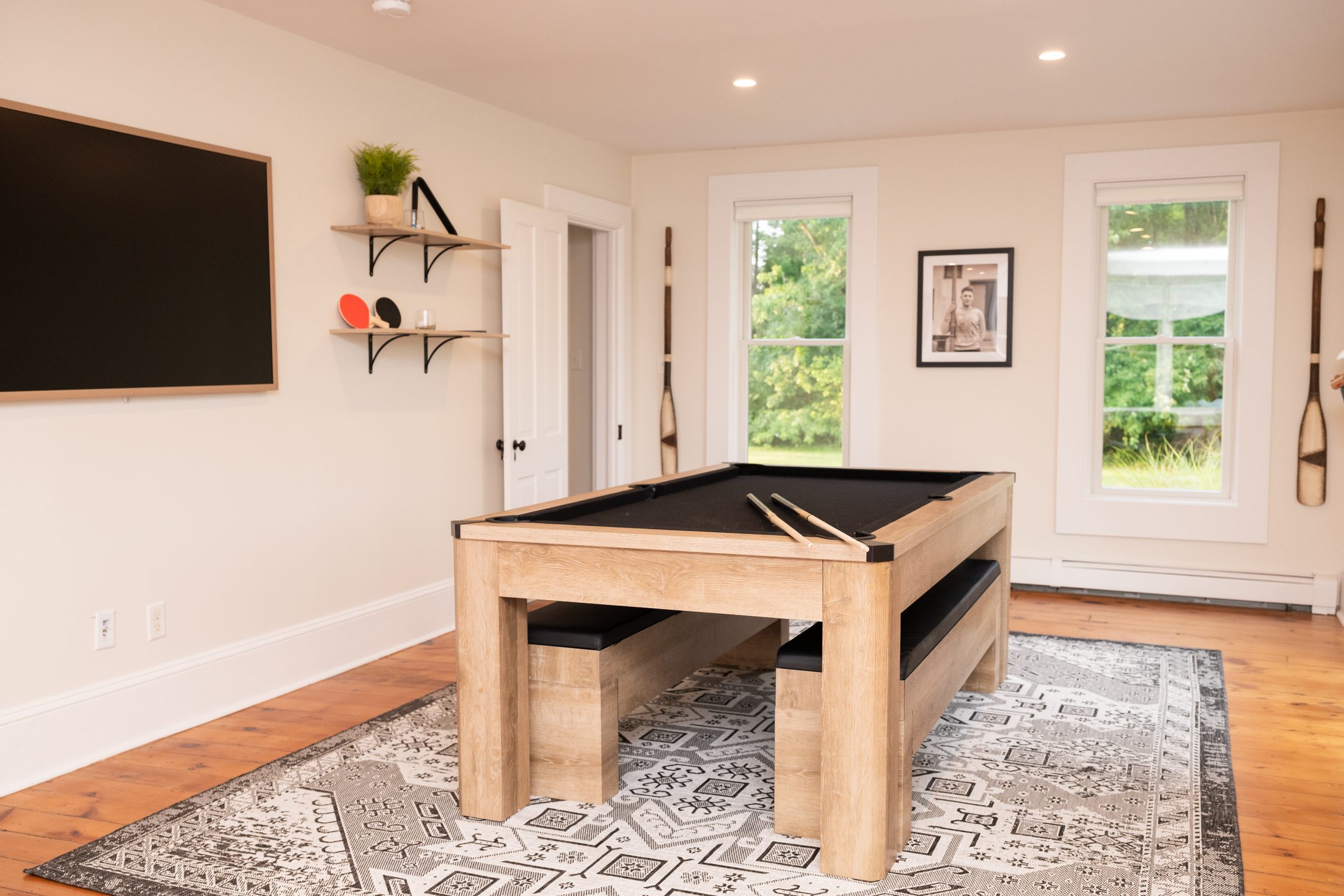 The riverfront sunroom with pool table and television