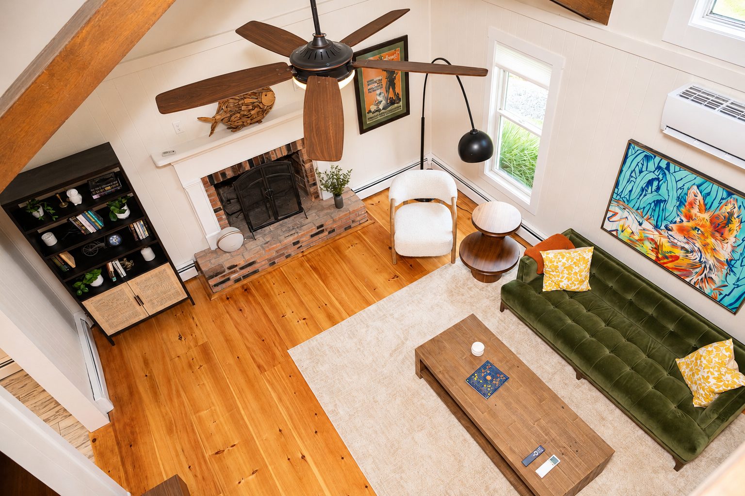 The great room with vaulted ceiling, exposed beams and wood-burning fireplace