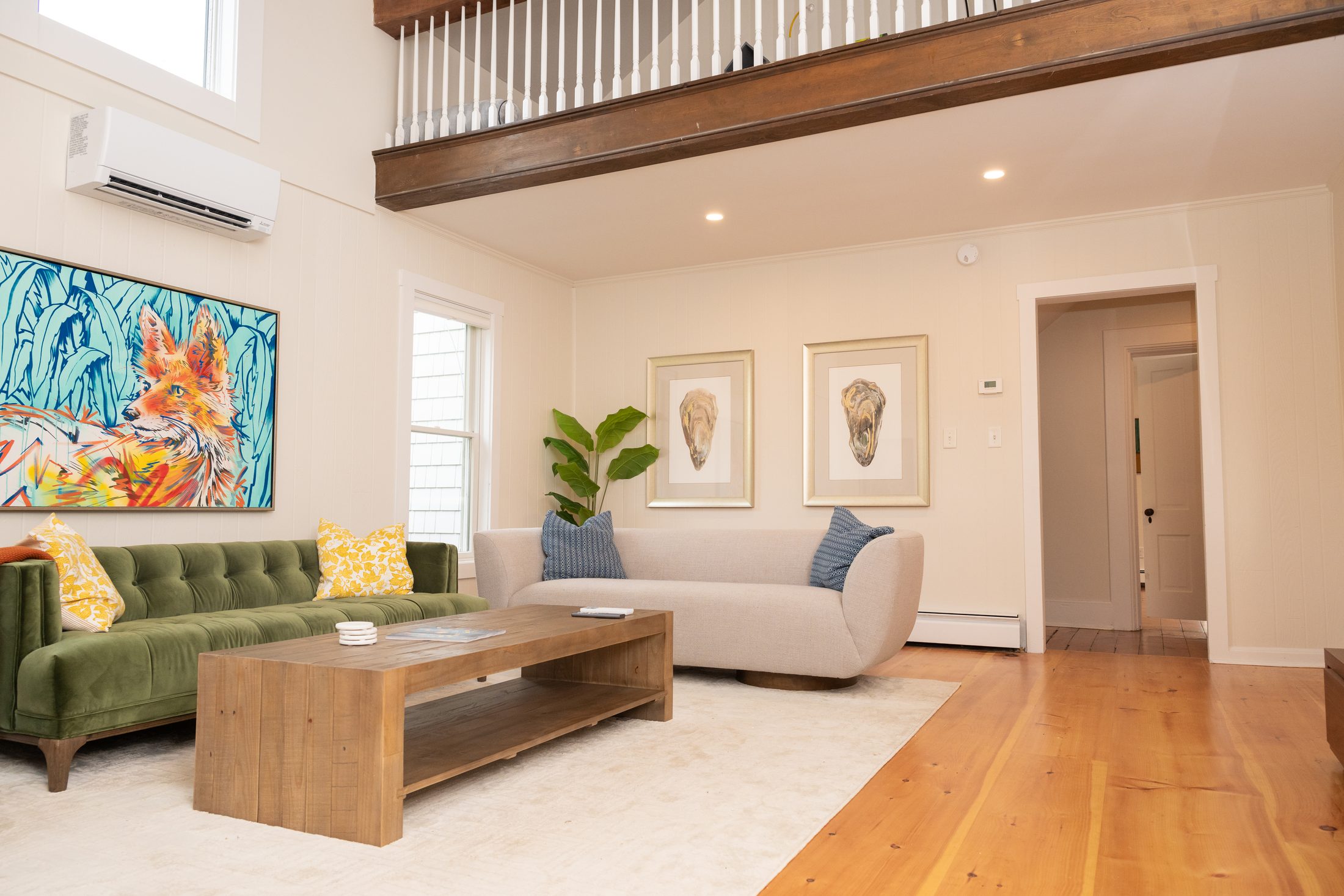 Living room seating beneath the vaulted ceiling and exposed beams
