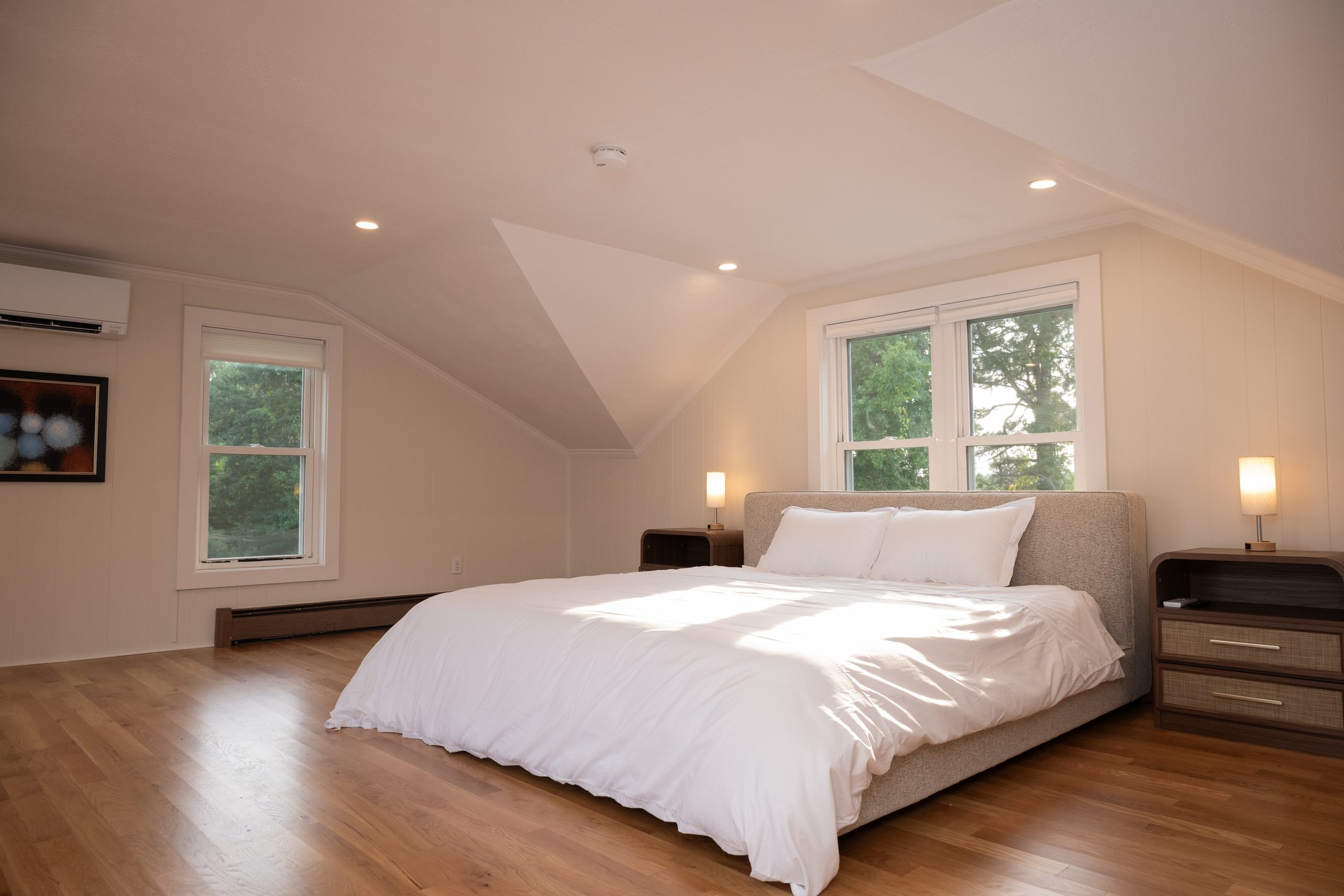 Primary bedroom with king bed and windows onto the river