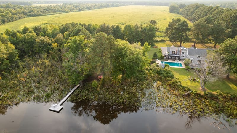The private dock in the foreground with the farmhouse across the water
