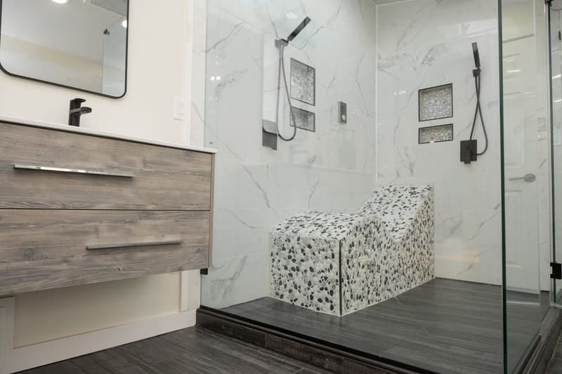 Marble walk-in shower with built-in bench