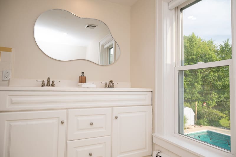Double vanity with a window onto the grounds
