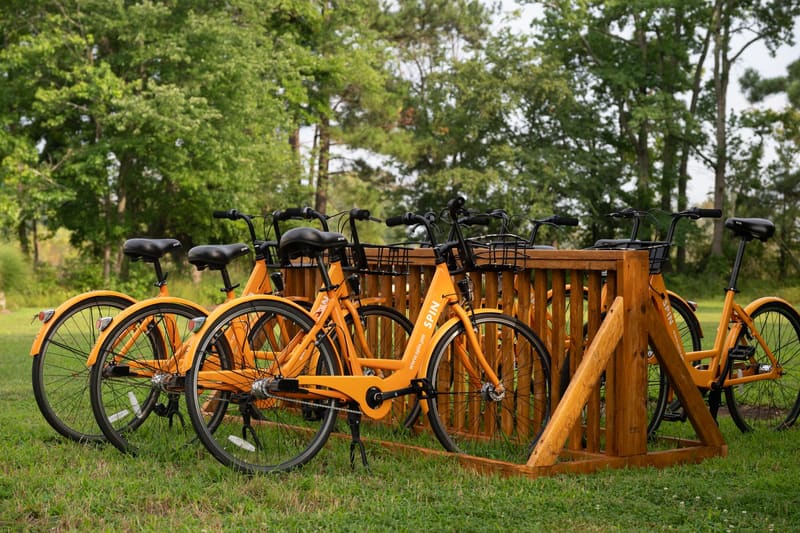 Orange cruiser bikes lined up on the bike rack