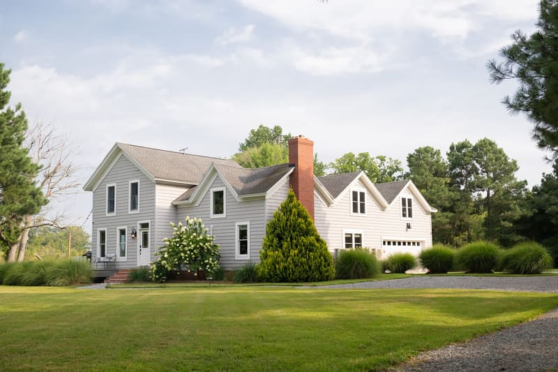 The farmhouse across the open lawn