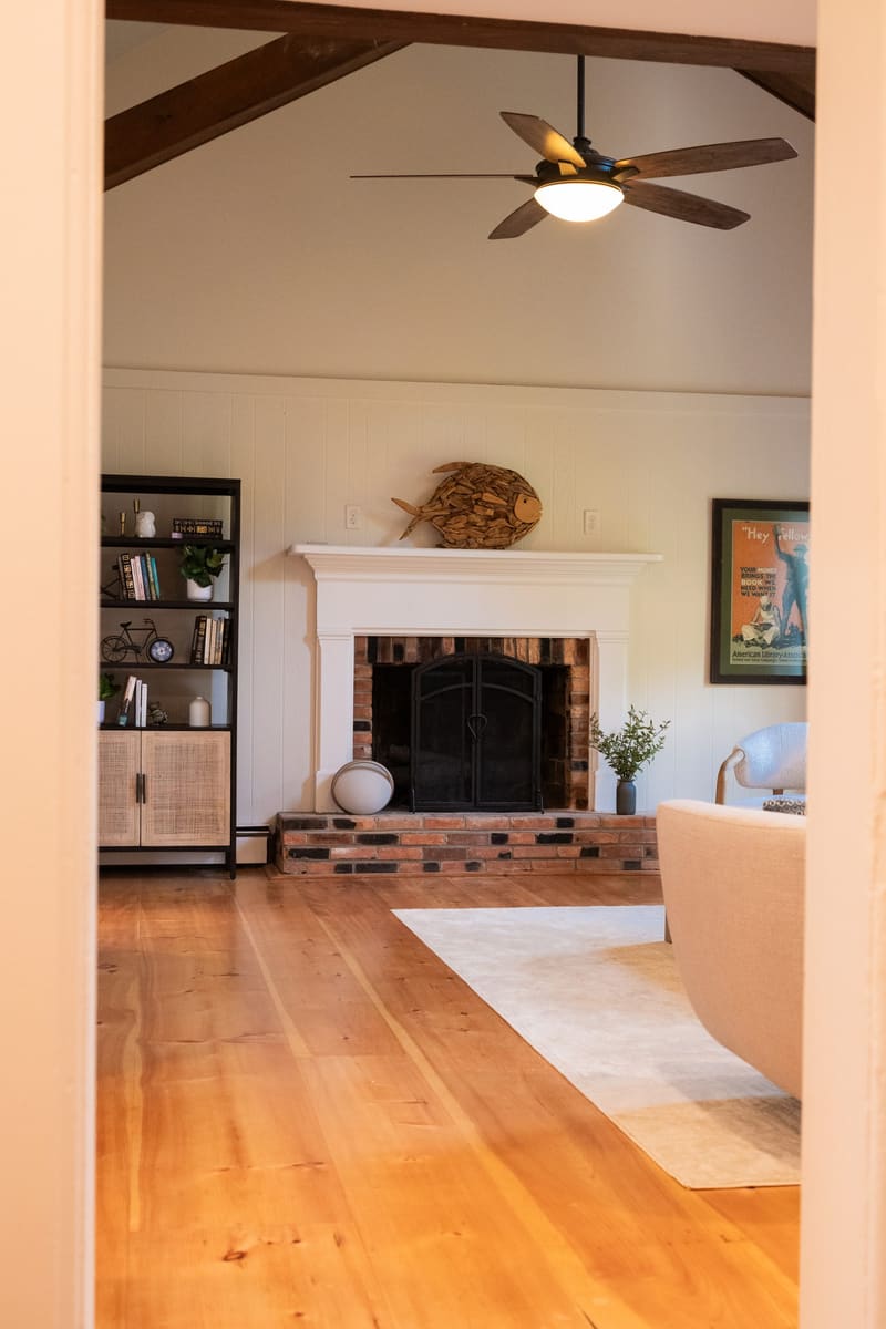The brick wood-burning fireplace and built-in shelving