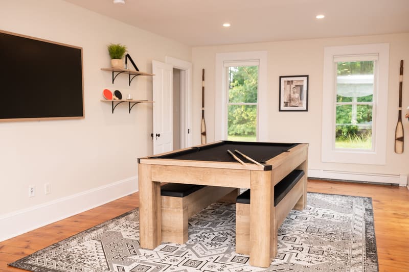 The riverfront sunroom with pool table and television