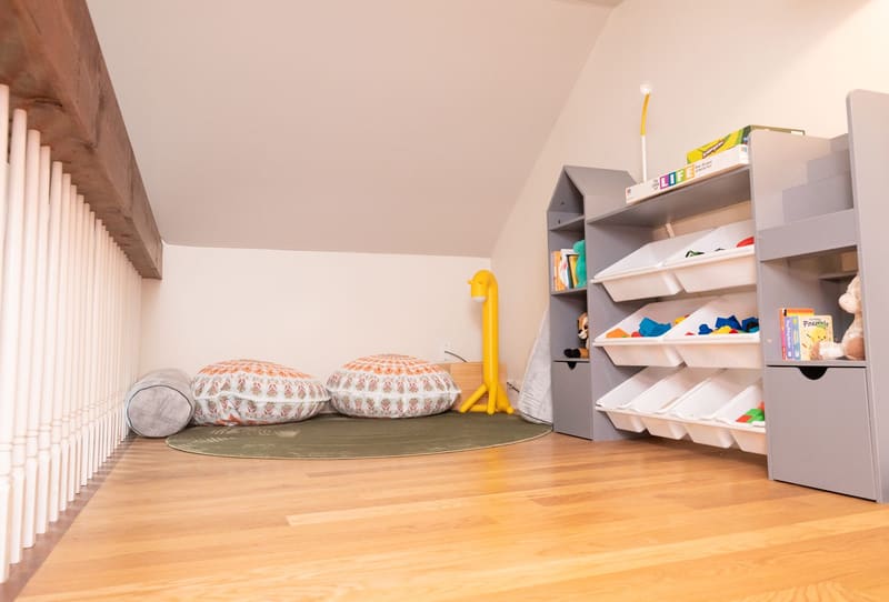 The kids play area with toy storage and floor cushions