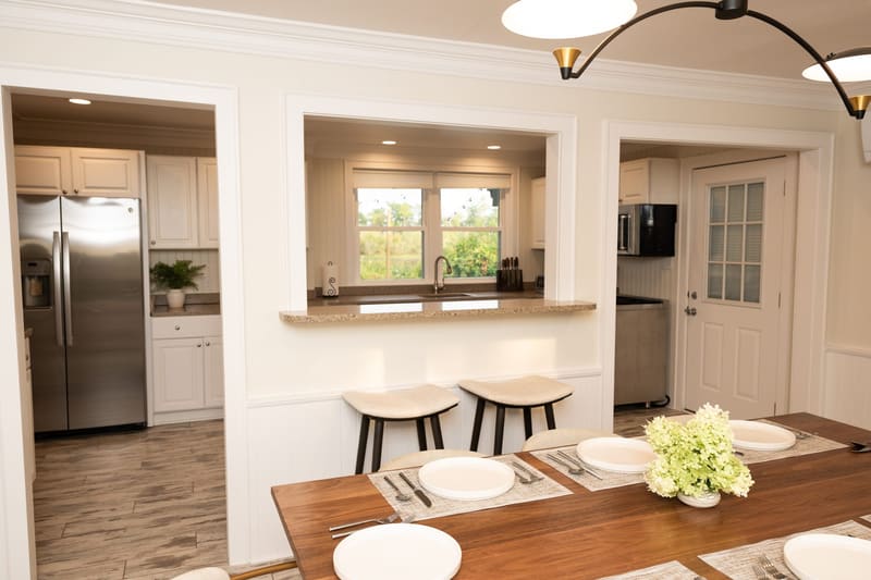 The kitchen opening onto the dining table