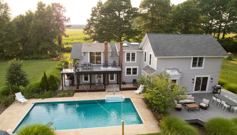 Aerial view of the farmhouse, decks and in-ground pool