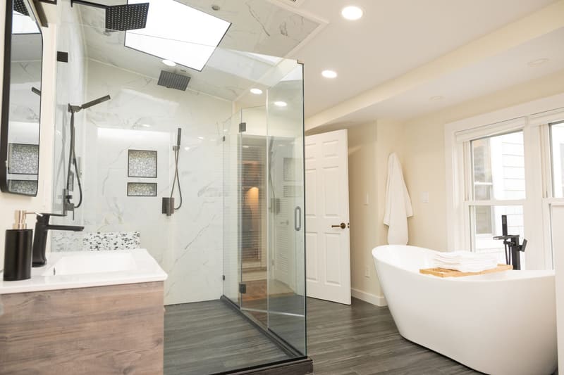Primary bath with glass steam shower and freestanding tub