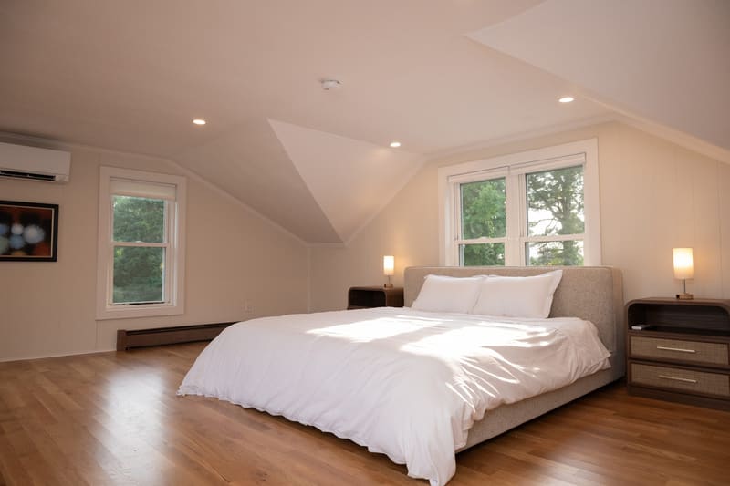 Primary suite with king bed under a vaulted ceiling