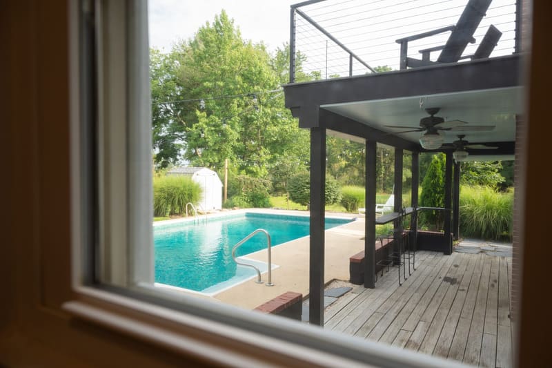 Looking out from the living room to the pool and deck