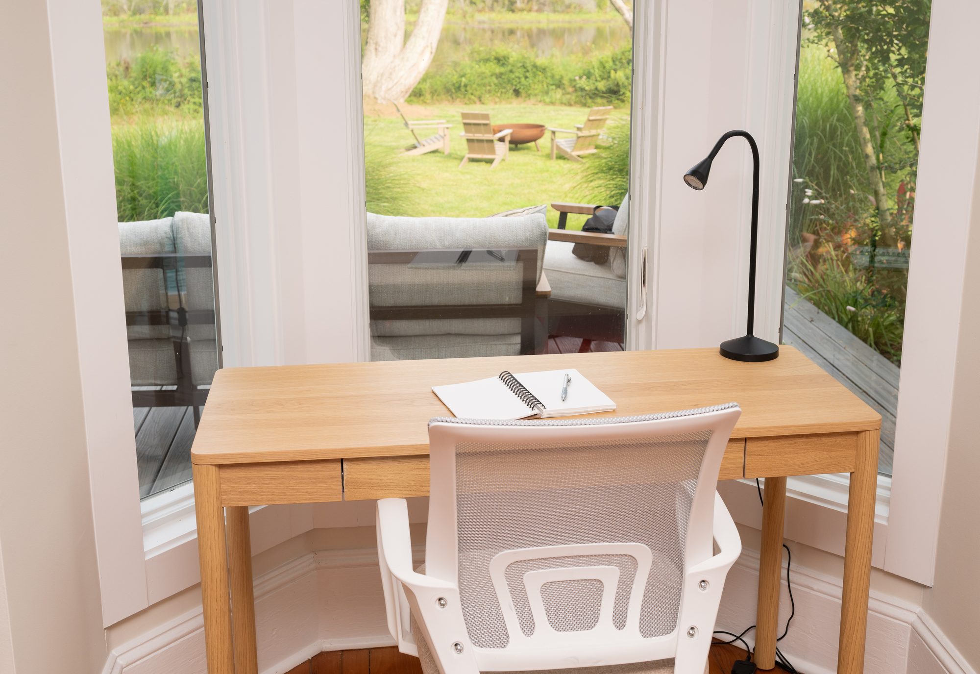 Desk and chair set against windows looking out to the river